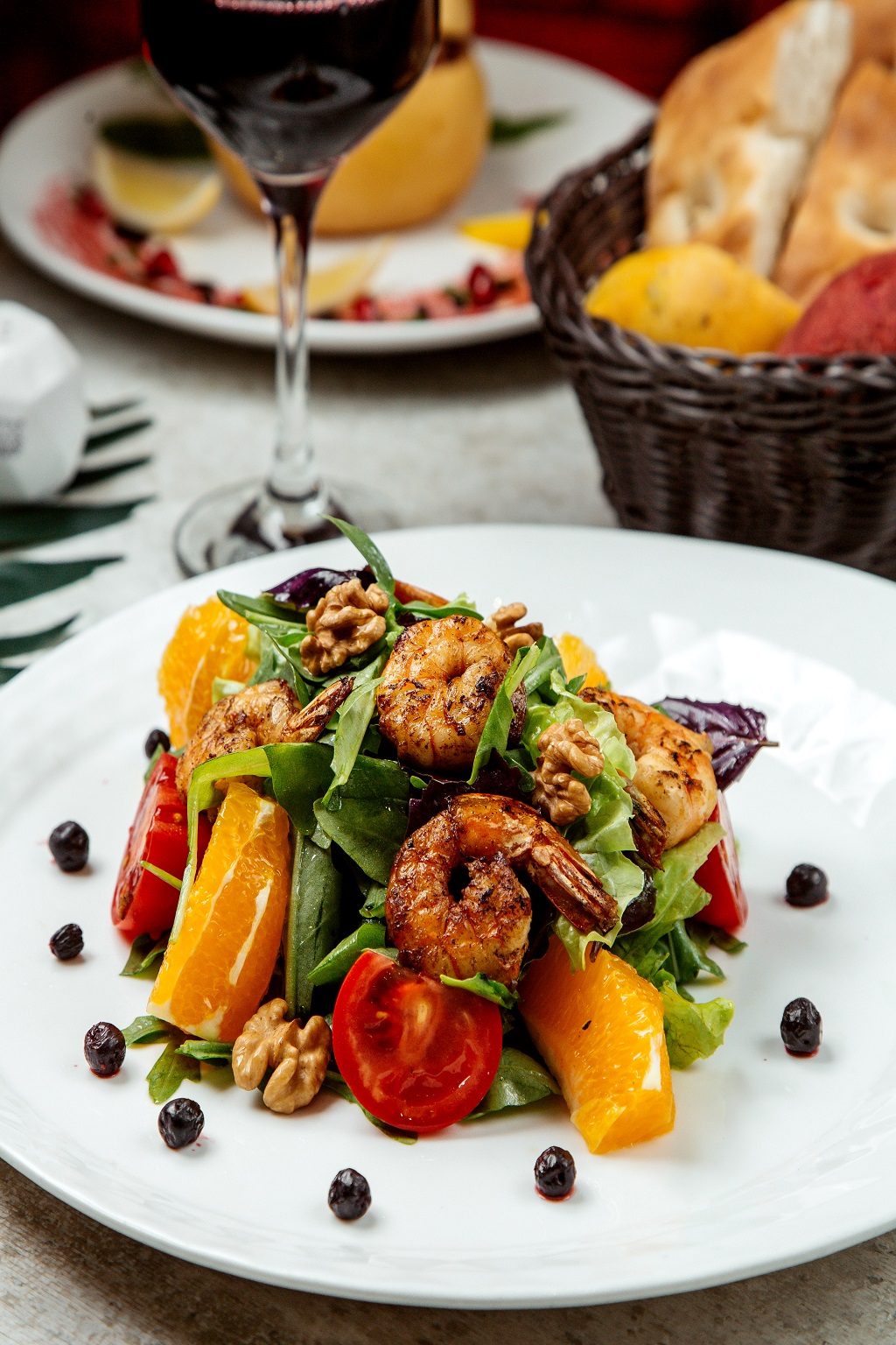 fried shrimp salad with lettuce arugula orange tomato walnut and dark opal basil